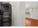 Stacked washer and dryer in a laundry room, with adjacent room's window providing natural light at 465 W Lakeshore Dr, Clermont, FL 34711