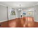 Open-concept living room with hardwood floors, a fireplace, and lots of natural light offers a cozy atmosphere at 465 W Lakeshore Dr, Clermont, FL 34711