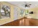 Open living room showcasing hardwood floors, a ceiling fan, and ample natural light at 465 W Lakeshore Dr, Clermont, FL 34711