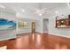Open-concept living room featuring hardwood floors, a front door view, and a convenient snack bar area at 465 W Lakeshore Dr, Clermont, FL 34711