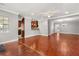 Spacious living area with hardwood floors and access to the kitchen and dining areas at 465 W Lakeshore Dr, Clermont, FL 34711