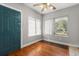 Bright living room with hardwood floors, ceiling fan, and natural light at 465 W Lakeshore Dr, Clermont, FL 34711