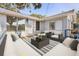 Charming outdoor patio with comfortable seating, a modern coffee table, and an elegant rug at 465 W Lakeshore Dr, Clermont, FL 34711