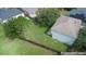Aerial view of backyard with privacy fence and mature trees in a neighborhood at 4756 Fiske Cir, Orlando, FL 32826