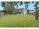 A large back yard with grass and a wood fence at 4756 Fiske Cir, Orlando, FL 32826