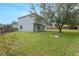Spacious, fenced back yard with green grass and mature tree offers privacy at 4756 Fiske Cir, Orlando, FL 32826