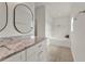 Bathroom features a granite countertop, double sink, soaking tub and tile floors at 4756 Fiske Cir, Orlando, FL 32826
