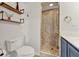 Bathroom features a glass shower with marble tile, wood shelves, and blue vanity at 4756 Fiske Cir, Orlando, FL 32826