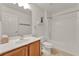 A bathroom with wood cabinets, a white sink, and shower with tub at 4756 Fiske Cir, Orlando, FL 32826