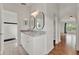 Bathroom features a granite countertop, double mirrors, an arched doorway, and tile floors at 4756 Fiske Cir, Orlando, FL 32826