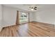 Spacious bedroom featuring wood-style flooring, a ceiling fan, and a large window at 4756 Fiske Cir, Orlando, FL 32826