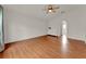 Large bedroom with wood-look floors, white dresser, archway, and ceiling fan at 4756 Fiske Cir, Orlando, FL 32826