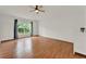 Bedroom showcases wood-look floors, large window, and ceiling fan at 4756 Fiske Cir, Orlando, FL 32826
