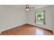 Bedroom features wood-look floors, a ceiling fan, and a window with curtains at 4756 Fiske Cir, Orlando, FL 32826