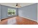 This bedroom has light blue walls, wood floors, and a ceiling fan at 4756 Fiske Cir, Orlando, FL 32826