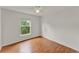 This bedroom has a ceiling fan, wood floors, and a large window at 4756 Fiske Cir, Orlando, FL 32826