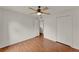 Bedroom with wood-look floors, closet, ceiling fan, and entry door at 4756 Fiske Cir, Orlando, FL 32826