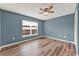 Comfortable bedroom featuring wood-style flooring, a ceiling fan, and a window at 4756 Fiske Cir, Orlando, FL 32826