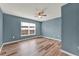 Cozy bedroom featuring wood-style flooring, a ceiling fan, and a window at 4756 Fiske Cir, Orlando, FL 32826