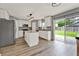 Bright kitchen with stainless steel appliances, center island, and sliding door access to the backyard at 4756 Fiske Cir, Orlando, FL 32826