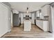 Modern kitchen featuring stainless steel appliances, a center island, and hardwood style flooring at 4756 Fiske Cir, Orlando, FL 32826
