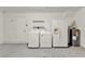 A well-lit laundry room with washer, dryer, water heater, and refrigerator at 4756 Fiske Cir, Orlando, FL 32826