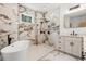 Luxurious bathroom features a soaking tub, marble tile, walk-in shower, and white vanity with black hardware at 4770 Drummond Ln, Orlando, FL 32810