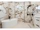 Luxurious bathroom features a soaking tub, marble tile, walk-in shower, and sleek black fixtures at 4770 Drummond Ln, Orlando, FL 32810