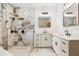 Bright bathroom showcases a tiled walk-in shower, double sink vanity, and elegant mirrors and light fixtures at 4770 Drummond Ln, Orlando, FL 32810