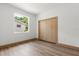 Bright bedroom featuring a closet, new flooring, and a window with views at 4770 Drummond Ln, Orlando, FL 32810