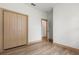 Bedroom features wood-look floors, white walls, neutral trim, and a closet offering ample storage space at 4770 Drummond Ln, Orlando, FL 32810