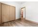 Bedroom features wood-look flooring, closet, white walls, and neutral trim, offering a serene and functional space at 4770 Drummond Ln, Orlando, FL 32810