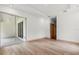 Well-lit bedroom with mirror closet doors, wood-look flooring, and modern recessed lighting at 4770 Drummond Ln, Orlando, FL 32810
