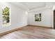 Bright bedroom featuring wood-look flooring, recessed lighting, and large windows offering abundant natural light at 4770 Drummond Ln, Orlando, FL 32810