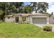 Charming single-story home with a well-manicured lawn and a two-car garage at 4770 Drummond Ln, Orlando, FL 32810