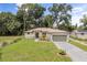 Charming home featuring a well-manicured lawn and a two car garage at 4770 Drummond Ln, Orlando, FL 32810