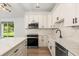 Modern kitchen with quartz countertops, stainless steel appliances, shaker cabinets, and a farmhouse sink at 4770 Drummond Ln, Orlando, FL 32810