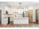 Modern kitchen with white cabinets, a center island, stainless steel appliances, and designer lighting fixtures at 4770 Drummond Ln, Orlando, FL 32810