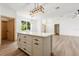 Kitchen island with shaker cabinets and granite countertops, plus modern lighting fixtures at 4770 Drummond Ln, Orlando, FL 32810