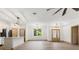 Spacious living room with a modern lighting fixture, wood-look flooring, and an entrance door at 4770 Drummond Ln, Orlando, FL 32810