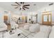 Bright, open-concept living space with modern furnishings, hardwood floors, and a ceiling fan at 4770 Drummond Ln, Orlando, FL 32810