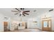 Bright and airy living room featuring modern lighting, wood-look flooring, and an open layout to the kitchen at 4770 Drummond Ln, Orlando, FL 32810