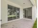 Covered patio with sliding glass doors overlooking the backyard at 4770 Drummond Ln, Orlando, FL 32810