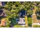 Aerial shot showcasing the home's layout, mature trees, and pool in a desirable community at 493 Princewood Dr, Deland, FL 32724