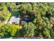 Aerial view of the property, surrounded by mature trees, highlighting the generous lot size at 493 Princewood Dr, Deland, FL 32724