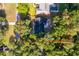 Overhead view of a home nestled among mature trees, highlighting its private location and backyard patio at 493 Princewood Dr, Deland, FL 32724