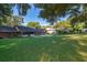 Wide shot of a large, grassy backyard, highlighting ample space and privacy at 493 Princewood Dr, Deland, FL 32724