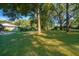 Large, private backyard featuring mature trees, providing ample shade and seclusion at 493 Princewood Dr, Deland, FL 32724