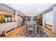 Open dining room with a large table, bench seating, and hardwood flooring at 493 Princewood Dr, Deland, FL 32724