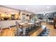 Open dining room with wood floors, a large table, and views of the living room at 493 Princewood Dr, Deland, FL 32724